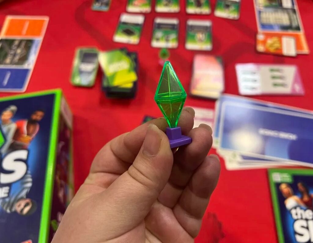The Sims Board Game: Gameplay Review & Release Date 11 Plumbob piece and game in background e1750519391759