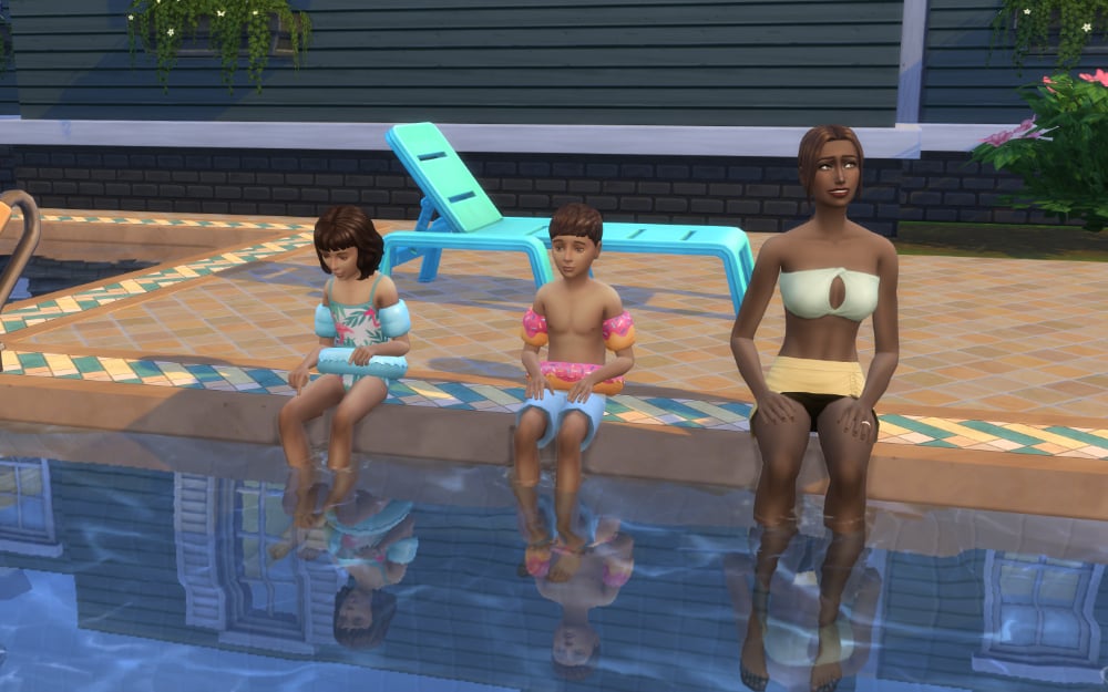 Sims sitting at pool