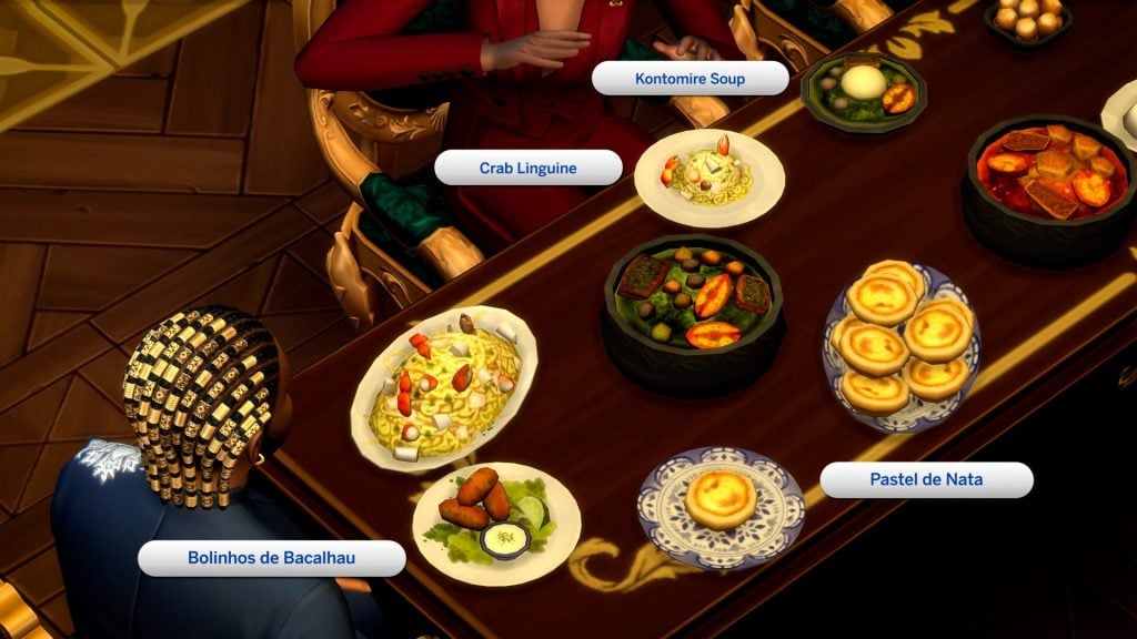 Overhead view of a dining table with labeled dishes including Kontomire Soup, Crab Linguine, Bolinhos de Bacalhau, and Pastel de Nata.