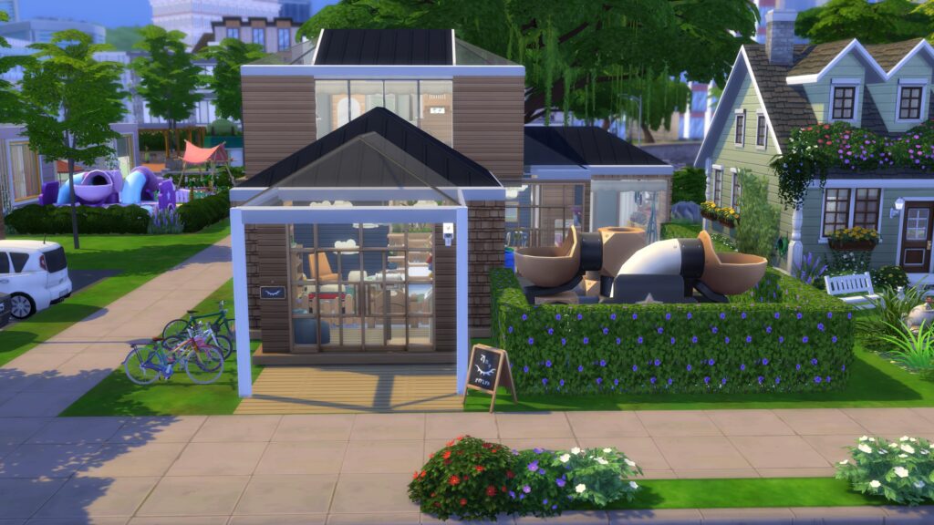One of the modern Sims 4 Gallery builds featuring a daycare with an upstairs apartment, large glass windows and outdoor playground.