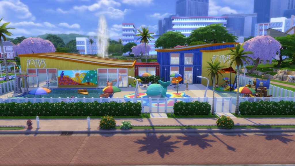 Colorful Sims 4 recreation center featuring an outdoor swimming pool, whale splash pad, tropical landscaping and bright community buildings.