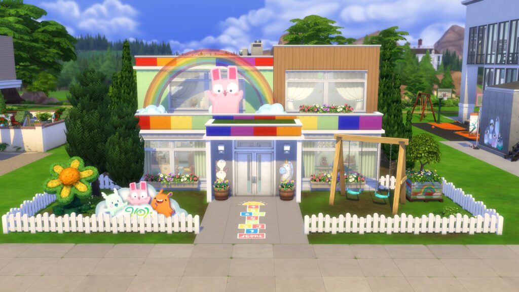 Two-story Sims 4 daycare with a rainbow bunny sign, colorful exterior, white picket fence and outdoor swings.